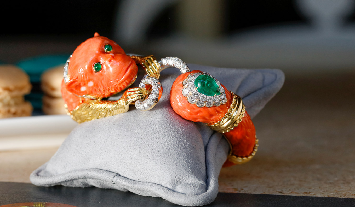 David Webb 'Monkey' bracelet with carved coral, cabochon emeralds and brilliant cut diamonds in 18k gold and platinum